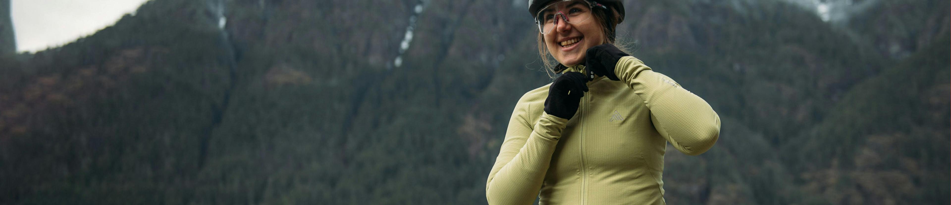 Woman adjusting her helmet while out on a road bike ride