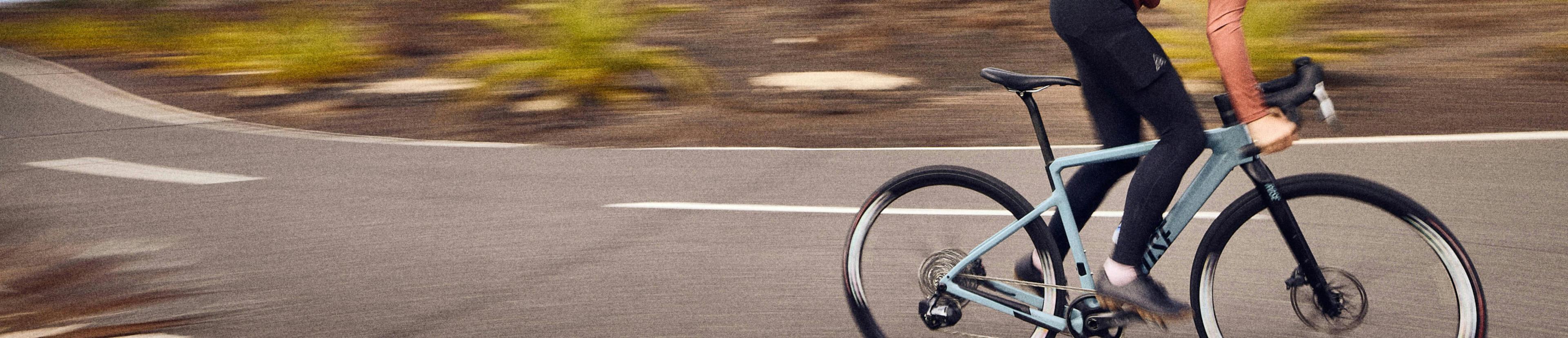 Woman wearing black tights riding a bike